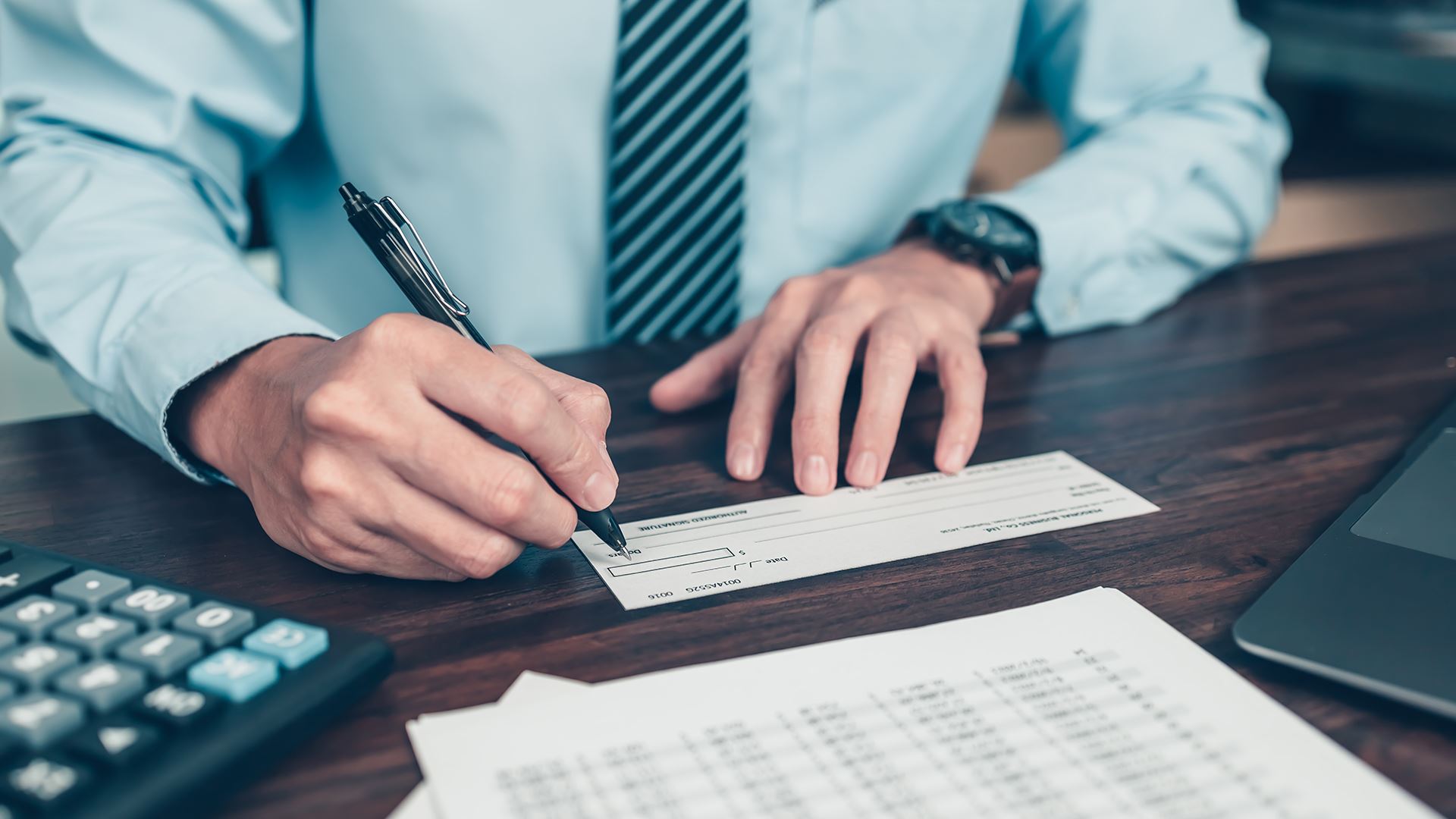 man writing a check